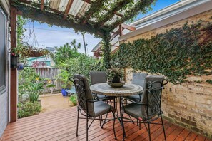 Step outside to the leafy patio, perfect for sipping morning coffee or enjoying relaxed dinners in the fresh air.