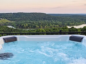 Unwind in the private hot tub overlooking Table Rock Lake and the stunning Ozark Mountains. This Branson family vacation home offers unforgettable views and  peaceful sunsets, just minutes from top Branson, MO attractions and lake adventures!