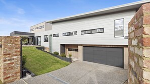  The peaceful front garden and coastal facade of Coastmere, a luxury holiday home in Rye, Mornington Peninsula