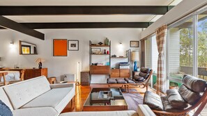 A mid-century modern living room with a cozy and inviting atmosphere. The perfect spot to unwind after a long day.