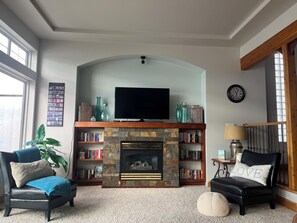 Main Floor Living Room has gas fireplace & book library.