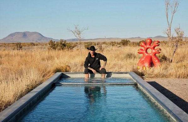 Douglas Friedman taking a dip with Haystack Mountain range in the background.