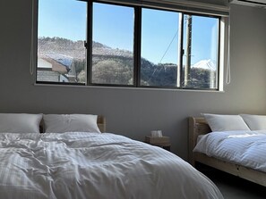 Bedroom with two double beds and a view of Mt. Fuji