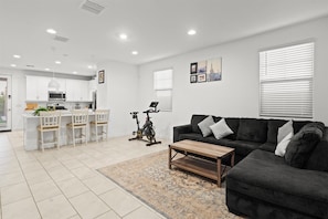 Stay connected while doing it all—whip up a meal in the fully stocked kitchen, chat with friends at the dining table, or relax on the plush sofa. This open-concept space brings everyone together in the heart of the home.
