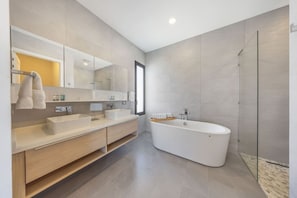 Unwind in style in the ensuite bathroom of Master Bedroom 2, located on the second floor. Featuring a sleek double vanity, walk-in shower, and a luxurious soaking tub—your private spa experience awaits.