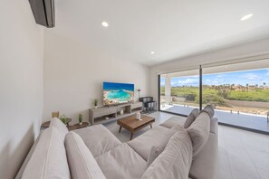 Bright, airy, and made for unwinding—this second-floor living room features cozy seating, large glass doors, and a balcony with sweeping views of Tierra del Sol. The perfect spot to relax and soak in the scenery.