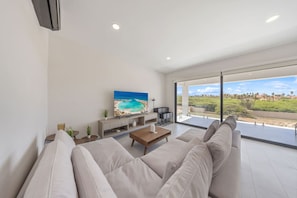 Bright, airy, and made for unwinding—this second-floor living room features cozy seating, large glass doors, and a balcony with sweeping views of Tierra del Sol. The perfect spot to relax and soak in the scenery.