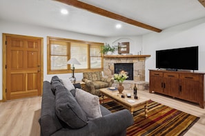 A warm and cozy living room with a fireplace and rustic decor.