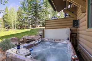 View of the bubbling hot tub surrounded by greenery.