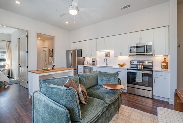 Unit 1: Living Room with a cozy, stylish sofa and music-inspired decor, creating the perfect spot to relax and unwind after a day in Nashville.