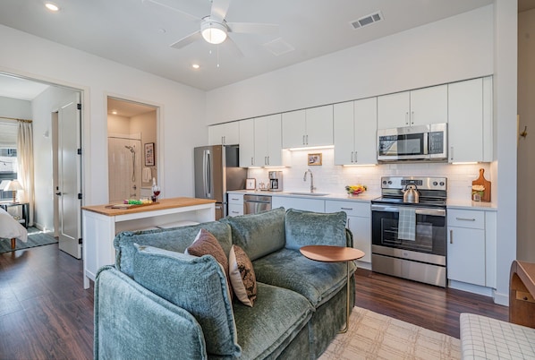 Unit 1: Living Room with a cozy, stylish sofa and music-inspired decor, creating the perfect spot to relax and unwind after a day in Nashville.
