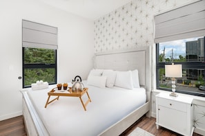 Unit 2: Primary bedroom with a King bed, en-suite jack-n-jill bathroom, and closet with smart TV.