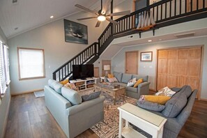 Den with Smart TV, games, laundry access, and entry to 2 main bedroom suites. 