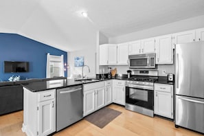 The open, airy kitchen offers ample space & every home comfort