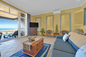 Lounge with a View
Kick back, catch a show, or soak up the ocean views — all from your sofa. Beach vibes just steps away.