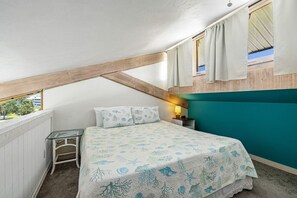 The loft bedroom sits above the ktichen and looks over the living room