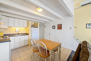 The bright eat in kitchen has everything you need for your stay (no oven)