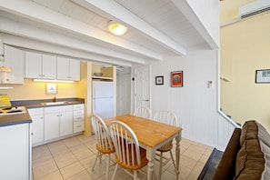 The bright eat in kitchen has everything you need for your stay (no oven)