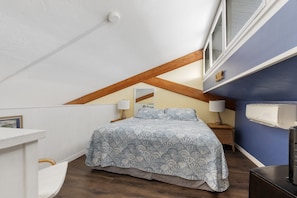The loft bedroom has comfortable king bed with night stands and reading lights