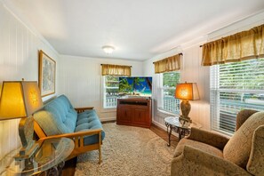The living room is comfortable for 4 with a smart TV
