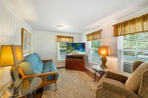 The living room is comfortable for 4 with a smart TV