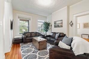 Unwind on plush leather sofas while enjoying a show on the flat screen smart TV