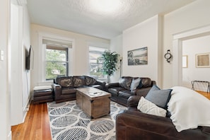 Unwind on plush leather sofas while enjoying a show on the flat screen smart TV