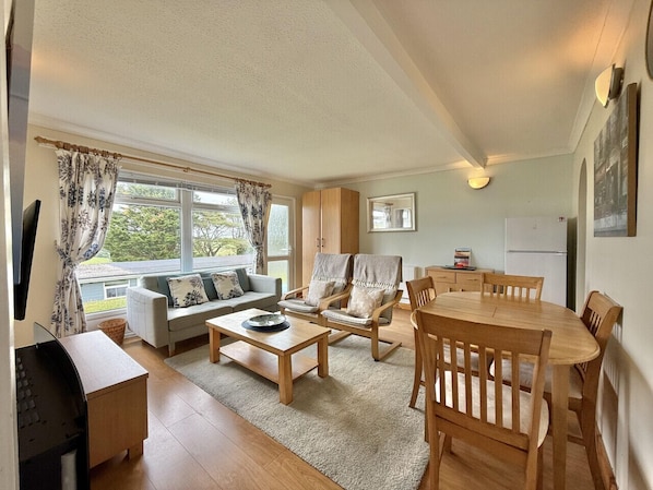 Open plan living, dining space with wardrobe and rural countryside views