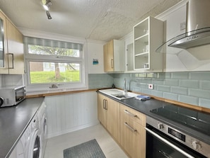 Well equipped galley kitchen with washing machine and tumble dryer