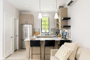Enjoy the airy ambiance of this contemporary kitchen, complete with top-of-the-line appliances and ample counter space.