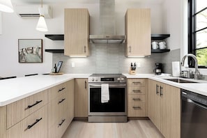 This inviting kitchen boasts a bright and open layout, featuring high-end appliances and stylish design elements.