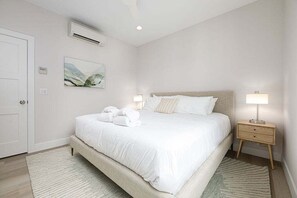 Enjoy a restful retreat in this bedroom,  featuring a queen-sized bed, cozy ambiance, and plenty of natural light