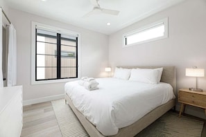Stretch out and relax in this spacious king bedroom, complete with soft linens, a mounted TV, and plenty of natural light.