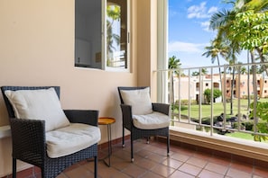 Ideal for sipping morning coffee or enjoying a sunset cocktail, this inviting scene creates a serene escape right at home. Embrace relaxation and coastal vibes with this delightful addition to your balcony.