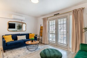 Living area with a green fold down sofa and a queen pullout sofa sleeps 3!