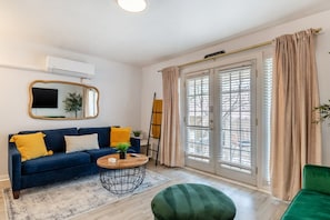 Living area with a green fold down sofa and a queen pullout sofa sleeps 3!