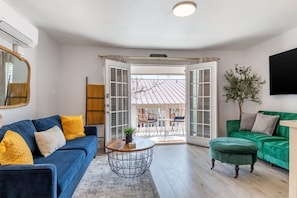 Living area with a green fold down sofa and a queen pullout sofa sleeps 3!