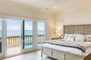 The third-floor master bedroom features a king bed, single pull-out sofa, ensuite bathroom, balcony access, and stunning ocean views.