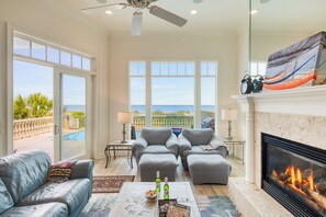 Ocean views from the living room, complete with comfy seating, a Smart TV, and a cozy fireplace for relaxing in style.