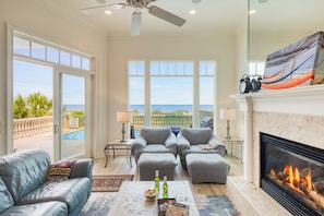 Ocean views from the living room, complete with comfy seating, a Smart TV, and a cozy fireplace for relaxing in style.