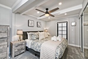 King sized primary bedroom with comfortable bedding