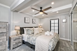King sized primary bedroom with comfortable bedding