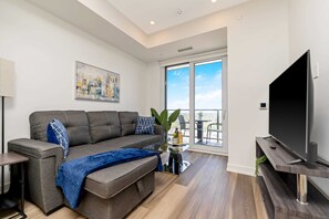 Bright Living Room With Comfortable Sofa Bed And A Smart TV