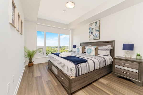 Bright Bedroom With A King Size Bed And Large Windows Offering Scenic Views