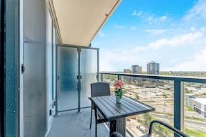 Private Balcony With Seating And Stunning Views Of The Cityscape