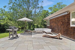 Spacious patio with outdoor dining and umbrella seating
