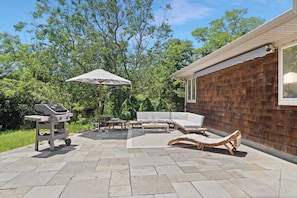 Spacious patio with outdoor dining and umbrella seating