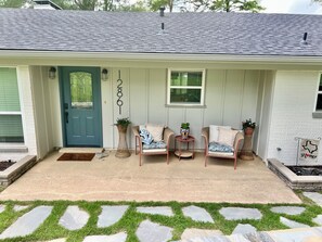 Covered front porch with comfortable seating.