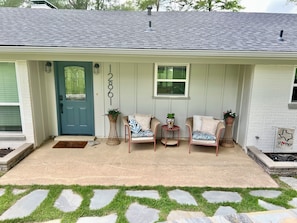 Covered front porch with comfortable seating.