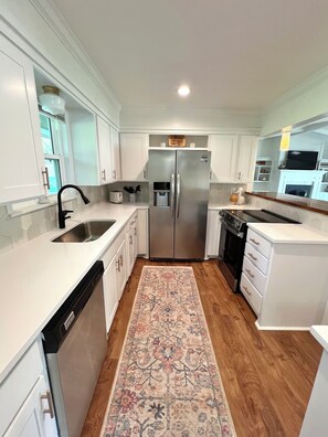 Updated kitchen with stainless appliances and basic cookware.